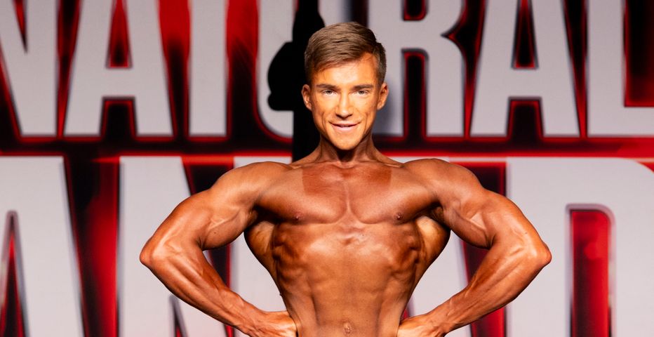 Matt Kennedy front facing bodybuilding pose on
          stage