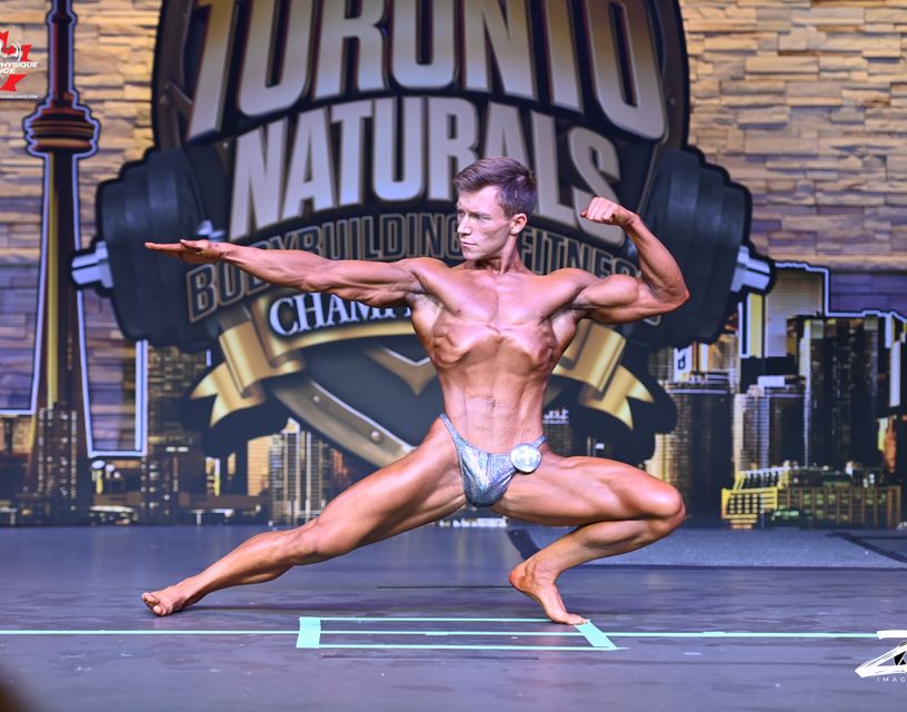 Matt Kennedy Posing on
          bodybuilding stage